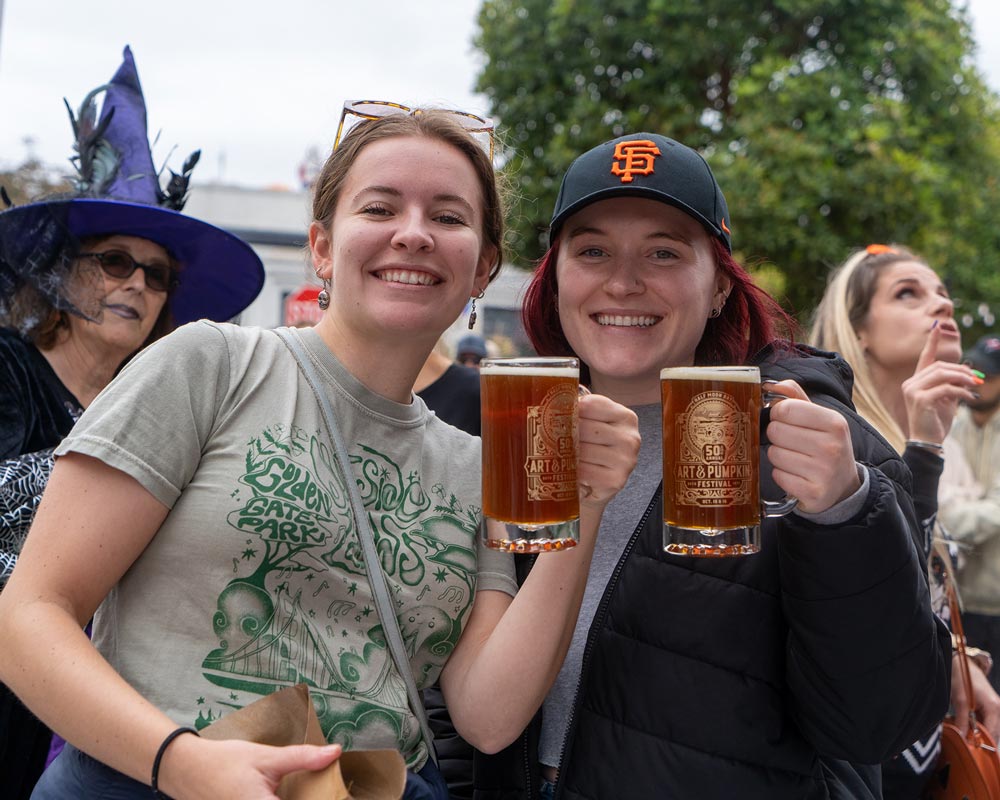 friends enjoy local beer in 50th event logo mugs